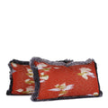 Pair of burnished orange decorative lumbar pillows with painterly ivory, violet and gold woven details and smoky violet silk brush fringe. Hand-sewn in Charlotte NC by Liz Saintsing.