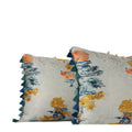 Detailed close up of a painterly woven decorative lumbar pillow in blue, coral and ochre with graduated blue tassel fringe. Hand-sewn in Charlotte NC by Liz Saintsing.